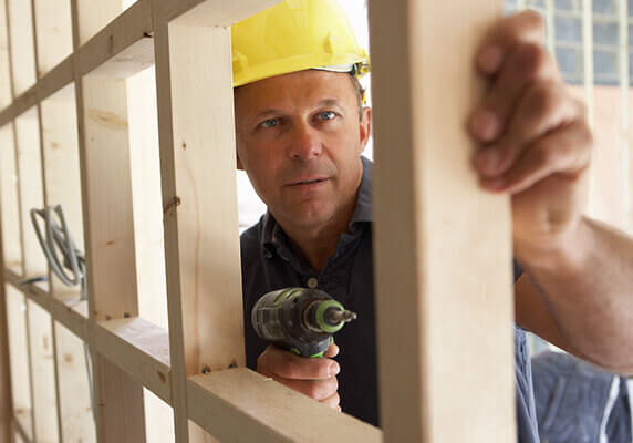 man framing a wall